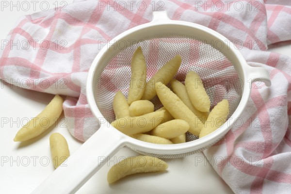 Raw Schupfnudeln in sieve, type of pasta, Germany