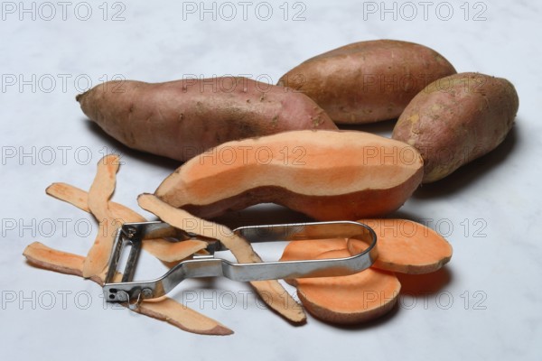 Sweet potatoes with potato peeler, Ipomoea batatas