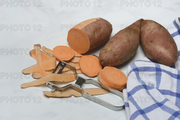 Sweet potatoes with potato peeler, potato slices, partially peeled, Ipomoea batatas