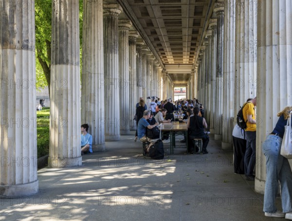Tourists and passers-by in the colonnade courtyard of the Neues Museum, Bodestraße in Berlin Mitte, Germany