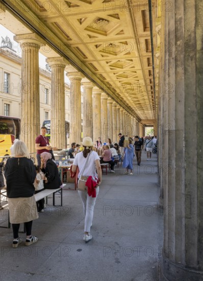 Tourists and passers-by in the colonnade courtyard of the Neues Museum, Bodestraße in Berlin Mitte, Germany