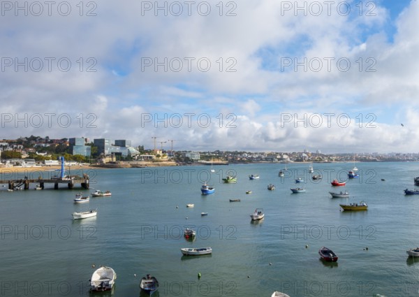 View of fishing boats and a small stretch of beach by the sea, Cascais, Portugal