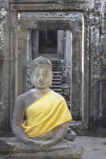Sandstone Buddha statue, (Bhumispara-mudra: Buddha Gautama at the moment of enlightenment), with tunic, Angkor Wat, Angkor Archaeological Park, Siem Reap, Cambodia