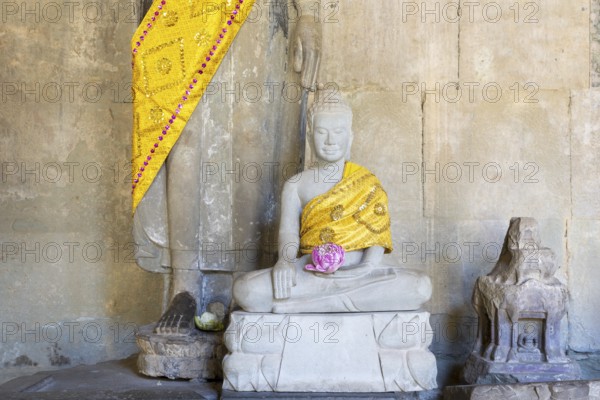 Sandstone Buddha statues, (Bhumispara mudra: Buddha Gautama in the moment of enlightenment), with tunic and lotus flower, Angkor Wat, Angkor Archaeological Park, Siem Reap, Cambodia