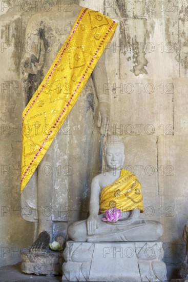 Sandstone Buddha statues, (Bhumispara mudra: Buddha Gautama in the moment of enlightenment), with tunic and lotus flower, Angkor Wat, Angkor Archaeological Park, Siem Reap, Cambodia