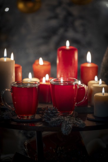 Close-up of red and white candles with tea in cups, Christmas background