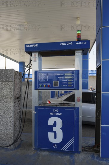 CNG station with blue gas pump, methane display and vehicle in background, gas filling station, Sewan, Gegharkunik province, Armenia