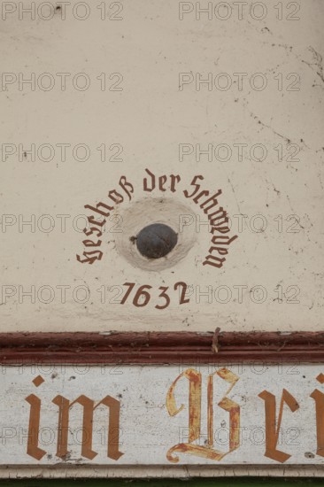 Old cannonball from 1632 in the wall of the bridge house on the Nahe bridge in Bad Kreuznach, Germany. Bullet of the Swedes