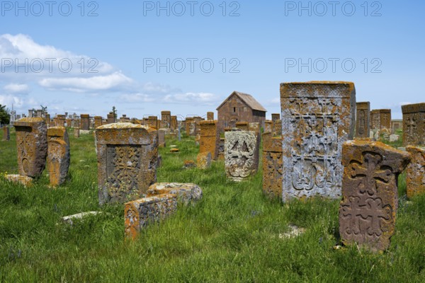 Ancient tombstones with carved patterns on an extensive green meadow, cross stones, khachkars, world's largest khachkar field, Noratus cemetery, Noradus, Gegharkunik province, Armenia