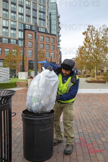Washington, DC USA - 27 November 2025 - On Thanksgiving Day, a Hispanic worker is on the job picking up trash. He is working for the Capitol Riverfront Business Improvement District