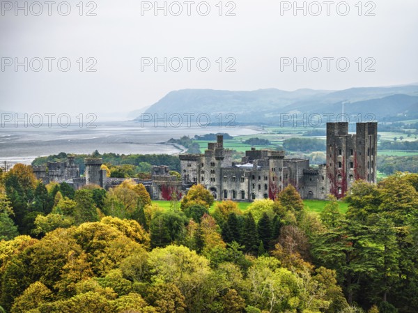 Autumn colours over Penrhyn Castle and Garden from a drone, Llandygai, Bangor, Gwynedd, North Wales, UK