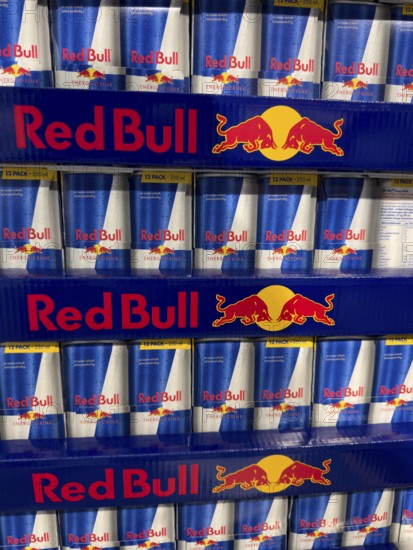 Red Bull soft drink in stacked aluminum cans aluminum cans at retail grocer, Germany