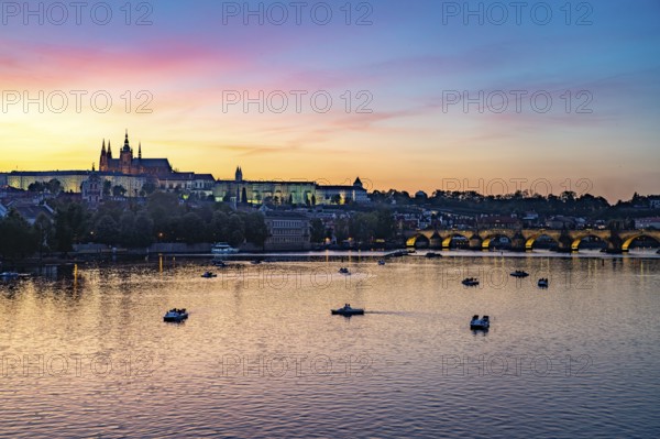 Sunset over the Vltava River, Charles Bridge and Prague Castle in Prague, Czech Republic