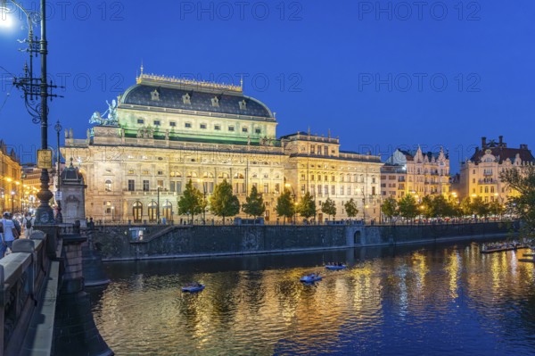 Vltava embankment with the Academy of Arts, Architecture and Design at dusk, Prague, Czech Republic