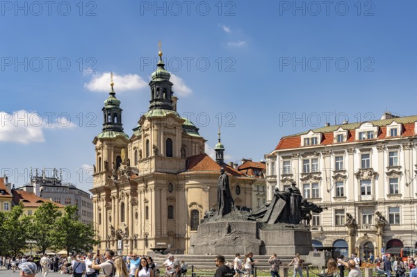 The Baroque St. Nicholas Church and the Jan Hus Memorial on Old Town Square in Prague, Czech Republic