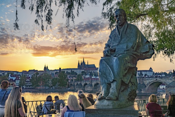 Statue of Bedrich Smetana on Novotný Bridge at sunset, Prague, Czech Republic