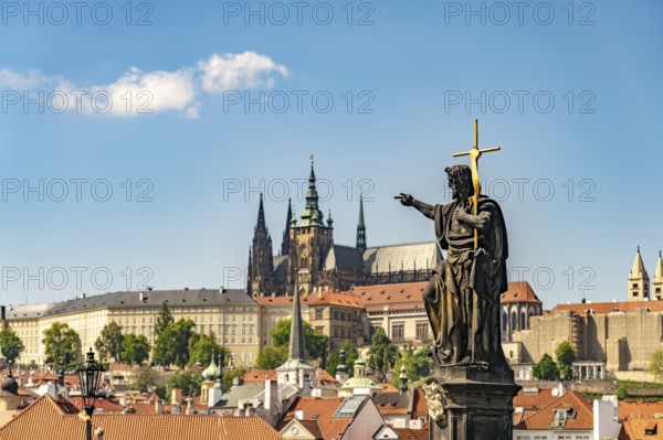 Statue of Saint John the Baptist on Charles Bridge in front of Prague Castle, Prague, Czech Republic