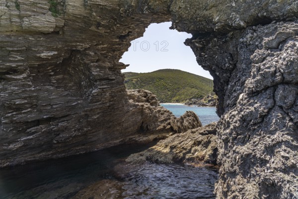 Rock with hole on Kalamos beach, Euboea or Evia island, Greece