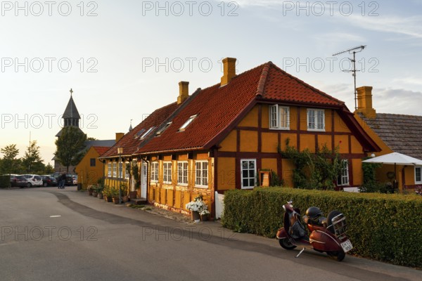 Characteristic half-timbered houses, street scene with church tower, Gudhjem, Bornholm, Baltic Sea, Denmark