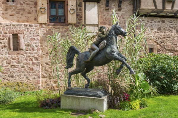 Statue of a woman riding with horse La Dame du Parc in Riquewihr