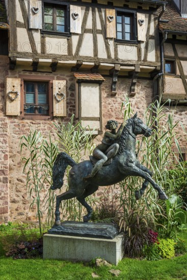 Statue of a woman riding with horse La Dame du Parc in Riquewihr
