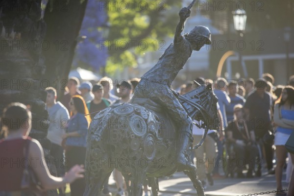 Metal sculpture of a polo player on the grounds of the polo stadium with many visitors, Buenos Aires, Argentina