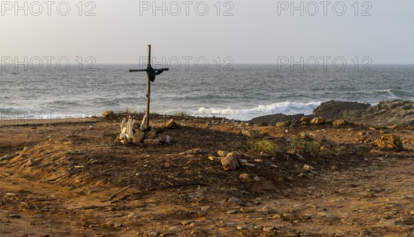 Religious scene, temporary Christian cross on the coast Farol de Cabo Raso lighthouse, São Bras de Sanxete fortress, Cascais, Portugal