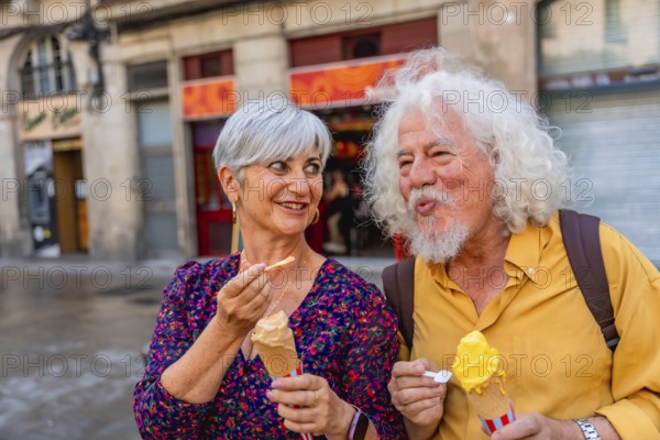Happy senior couple eating ice cream cones while walking on a city street, sharing a sweet moment together during their urban exploration and leisure time