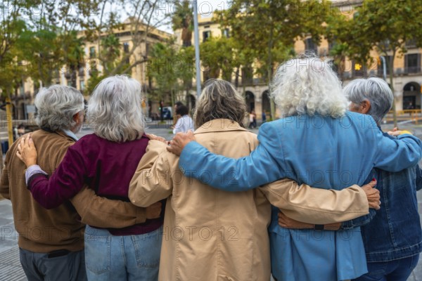 Group of diverse seniors walking together in a city, embracing with arms around each other, demonstrating strong friendship, support, and a sense of community outdoors