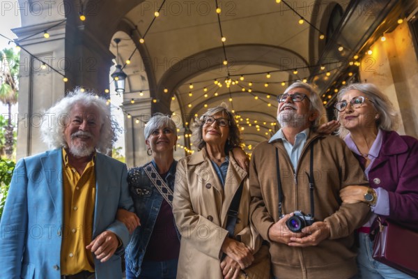 Senior friends strolling beneath a decorated arcade, smiling and looking up as they enjoy a sunny city sightseeing vacation, bonding over travel and shared memories