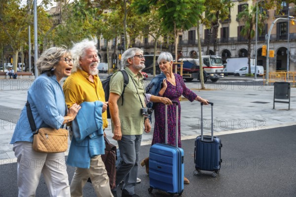 Group of happy senior friends smiling, walking along a city street and pulling luggage, enjoying their retirement vacation and active travel lifestyle