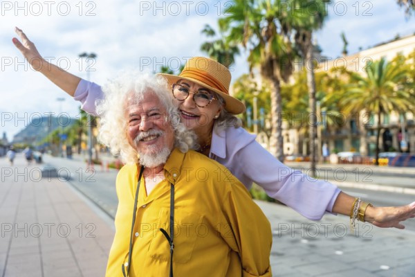 Senior couple laughing as husband gives wife a piggyback through sunlit city streets lined with palm trees, enjoying a carefree vacation together and making joyful memories