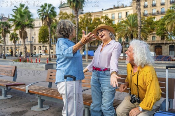 Diverse group of happy senior friends enjoying their city holiday together, laughing and communicating on a bench with their luggage, representing active and positive tourism