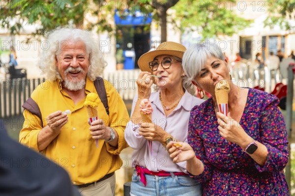 Group of happy senior friends smiling and eating ice cream cones outdoors, enjoying summer day and active golden years, reflecting happiness and friendship