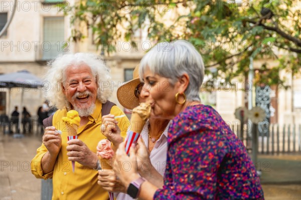 Senior friends laughing and enjoying gelato on a sunny city street, sharing joyful conversation and carefree leisure time together during a warm urban summer outing