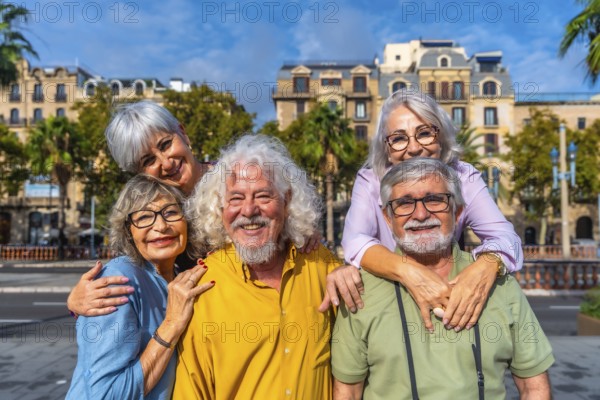 Smiling group of senior friends enjoying carefree retirement travel together in a sunny european city street, sharing laughter, friendship and happy leisure moments outdoors