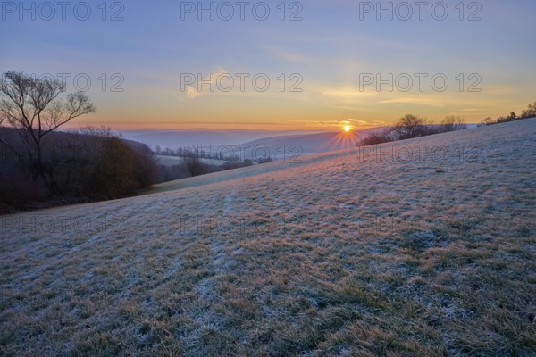A frosty morning with sunrise over a rolling landscape, Seckmauern, Lützelbach, Maintal, Odenwald, Hesse, Germany