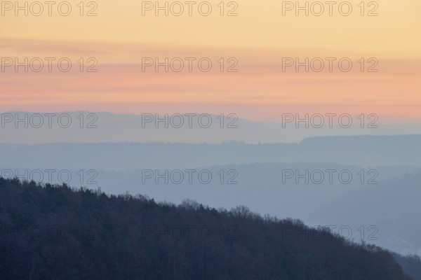 Pastel-colored silhouettes of hills and trees at sunset convey a peaceful atmosphere, Seckmauern, Lützelbach, Maintal, Odenwald, Hesse, Germany