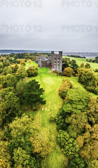 Autumn colours over Penrhyn Castle and Garden from a drone, Llandygai, Bangor, Gwynedd, North Wales, UK