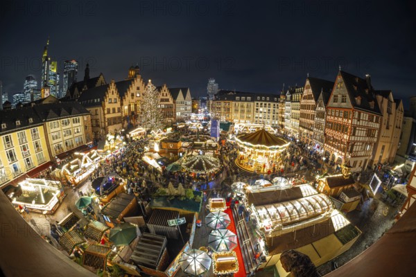 With the lighting on the Mrs. Holle Christmas tree, a 30-meter high Nordmann fir tree, the Frankfurt Christmas Market was officially opened on 24.11.2025. The Christmas market will be open until December 22 from Monday to Saturday from 10:00 to 21:00 and on Sundays from 11:00 to 21:00, Römerberg, Frankfurt am Main, Hesse, Germany