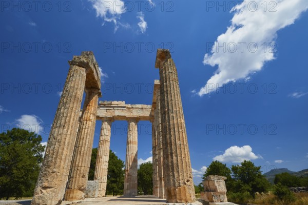 Pillars of an ancient structure under a clear sky with few clouds, Nemea, Ancient Zeus Heightum, Archaeological Site, Peloponnese, Greece