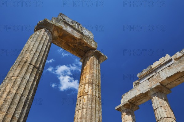 Ancient columns rising into the clear sky, Nemea, Ancient Zeus Church, Archaeological Site, Peloponnese, Greece