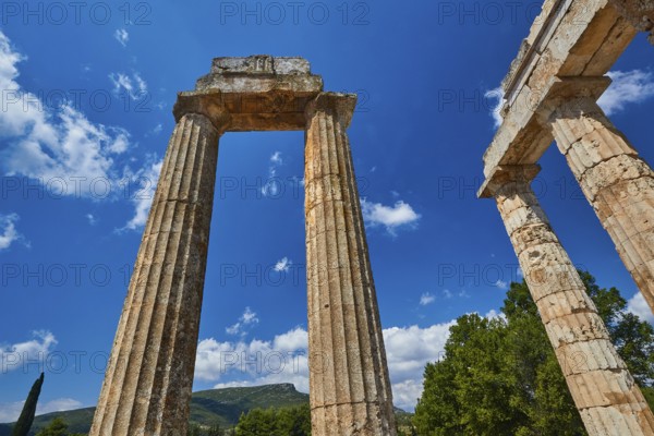 Single ancient column and ruins with clear sky, Nemea, Ancient Zeus Heightum, Archaeological Site, Peloponnese, Greece