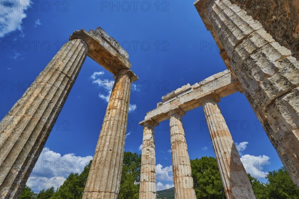 Ancient columns rising against a blue sky, Nemea, Ancient Zeus Heightum, Archaeological Site, Peloponnese, Greece