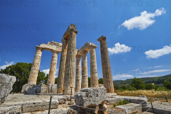 Ancient columns in a vast landscape under clear sky, Nemea, Ancient Zeus Heightum, Archaeological Site, Peloponnese, Greece