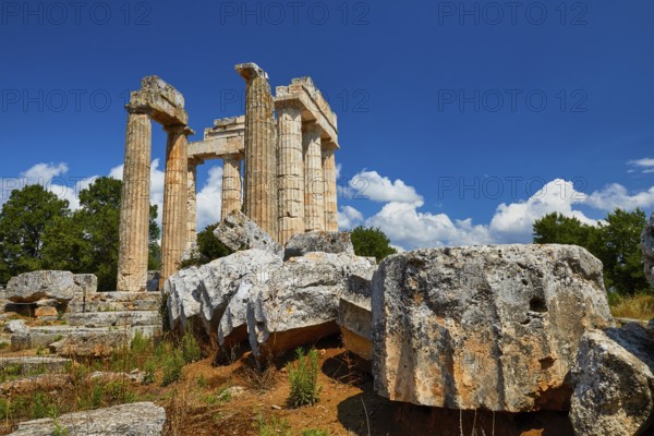 Ancient ruins and pillars under a cloudy blue sky, Nemea, Ancient Zeus Heightum, Archaeological Site, Peloponnese, Greece
