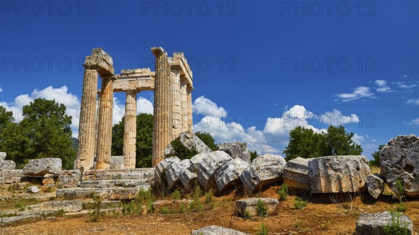 Ancient columns and ruins with loosely scattered stones in the foreground, Nemea, Ancient Zeus Heightum, Archaeological Site, Peloponnese, Greece