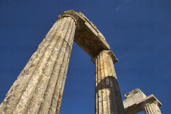 Close-up of an old pillar against a clear sky. Greek Ruins, Nemea, Ancient Zeus Heightum, Archaeological Site, Peloponnese, Greece