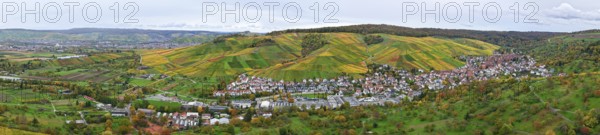 Panoramic view of an autumn-colored wine village surrounded by green hills and colorful vineyards, Strümpfelbach im Remstal, Rems-Murr-Kreis, Baden-Württemberg, Germany