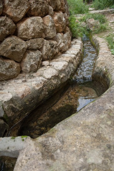 Small trickle on a laying stone wall, Majorca, Spain